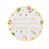 White enamel pin featuring a floral border and the text you are safe you are loved it will be okay