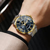 A close-up shot of a gold and silver luminous quartz wristwatch worn on a wrist against a dark background.