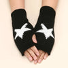 Black knitted half finger gloves with a white star pattern on the palm side