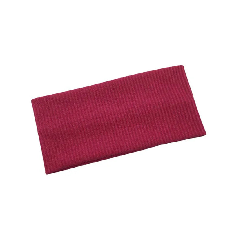 A maroon knitted sports headband designed for yoga and gym activities.