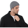 A man wearing a gray knitted beanie cap and a black zip-up jacket.