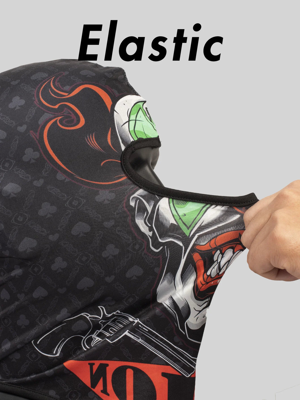 A close-up of an elastic full face balaclava helmet liner in black with orange and white graphics.