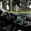 Interior view of a car showing a Virgin Mary Saint Jude Protection Catholic charm hanging from the rearview mirror