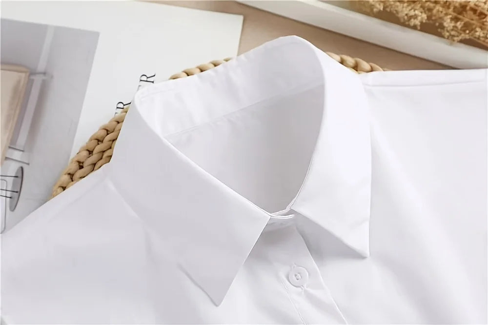 A close-up view of a white elegant detachable button-up collar shirt.