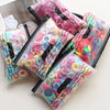 A collection of pink and multicolored elastic hair bands packaged in clear plastic.