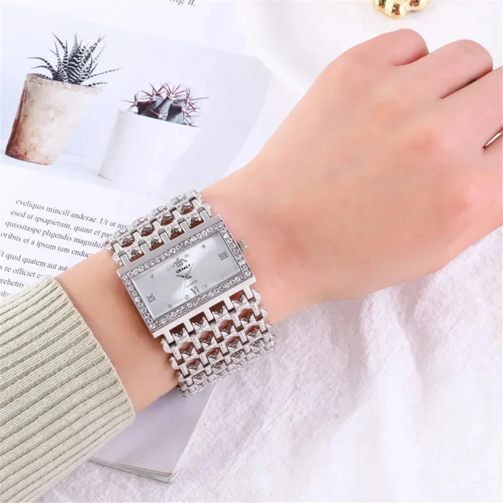 A close-up of a fashion quartz diamond watch with a gold stainless steel bracelet on a wrist.