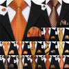 A collection of men's silk jacquard ties in various shades of orange, gold, and brown displayed on black backgrounds.
