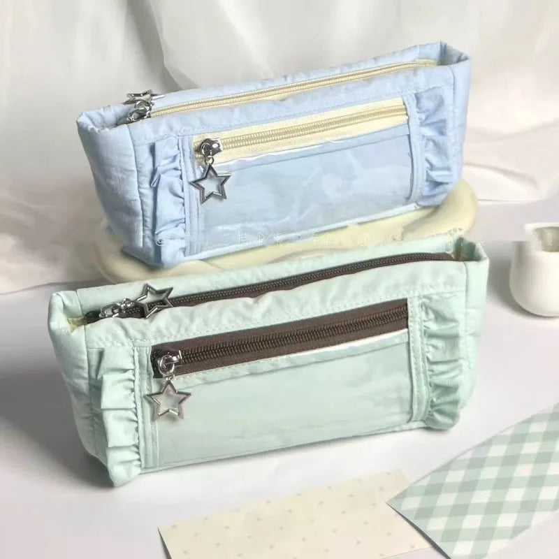Light blue lace pencil case with a zipper and star embellishments displayed on a white surface.