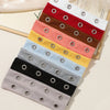 A stack of punk style metal hollow headbands in various colors including red, brown, pink, yellow, light blue, gray, and blac