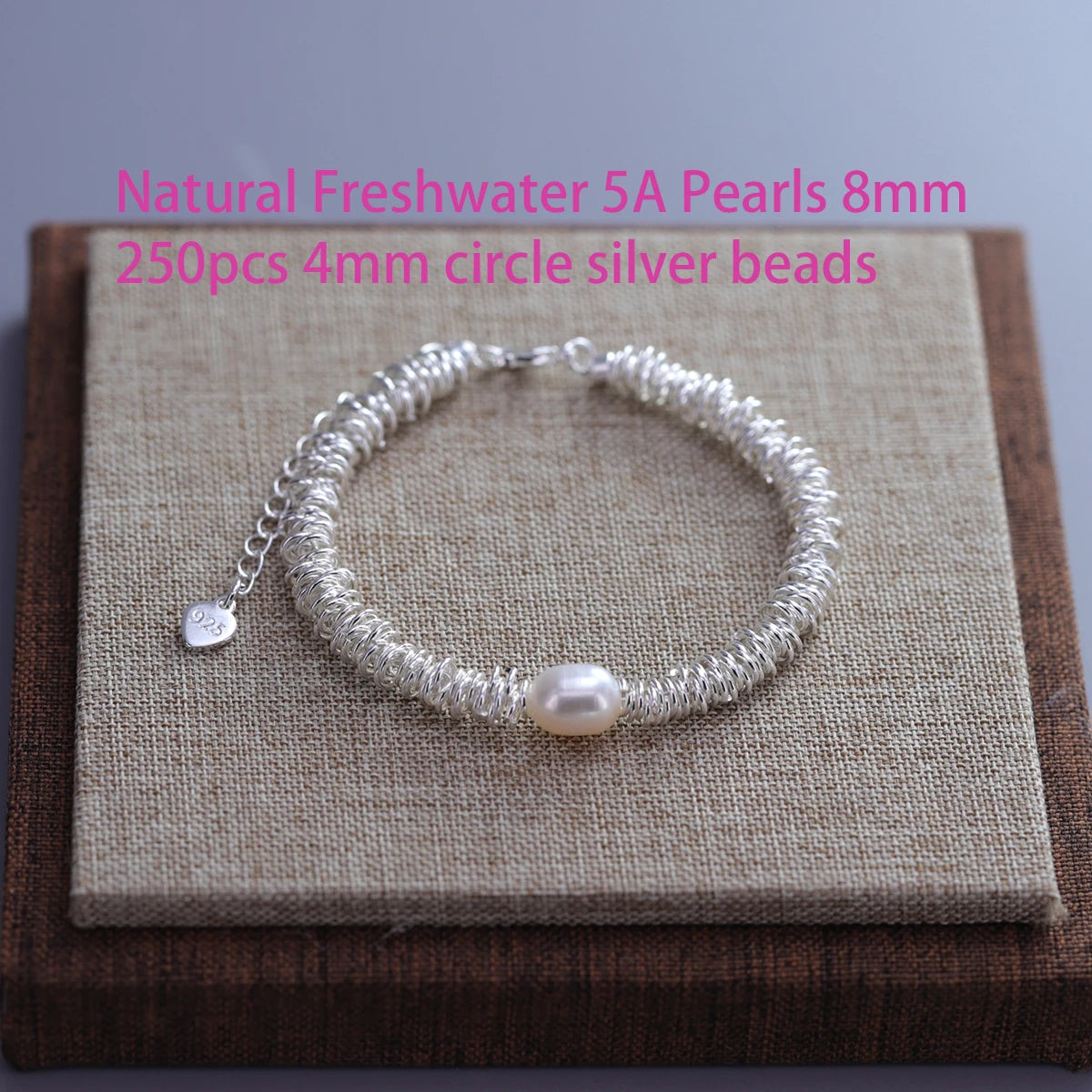 A silver bead bracelet featuring 5A freshwater pearls and 4mm silver beads with a double heart charm.
