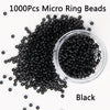 A pile of 1000 pieces of black micro ring beads in a clear container.