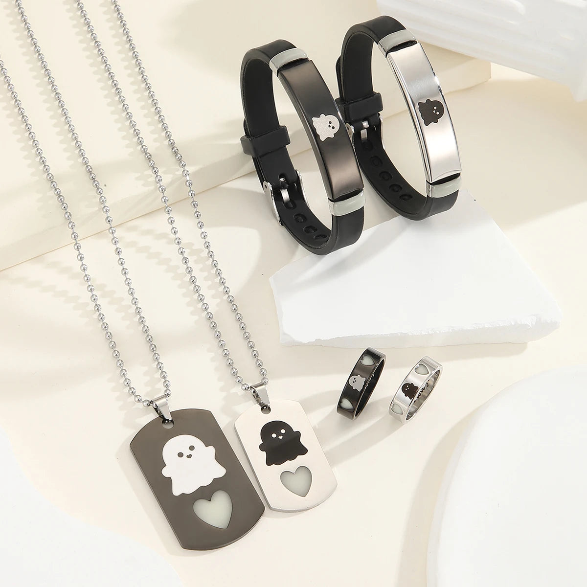 A set of six pieces including necklaces and bracelets featuring ghost motifs in silver and black tones.