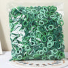 A bundle of green nylon elastic hair cords for kids headbands packaged in clear plastic.