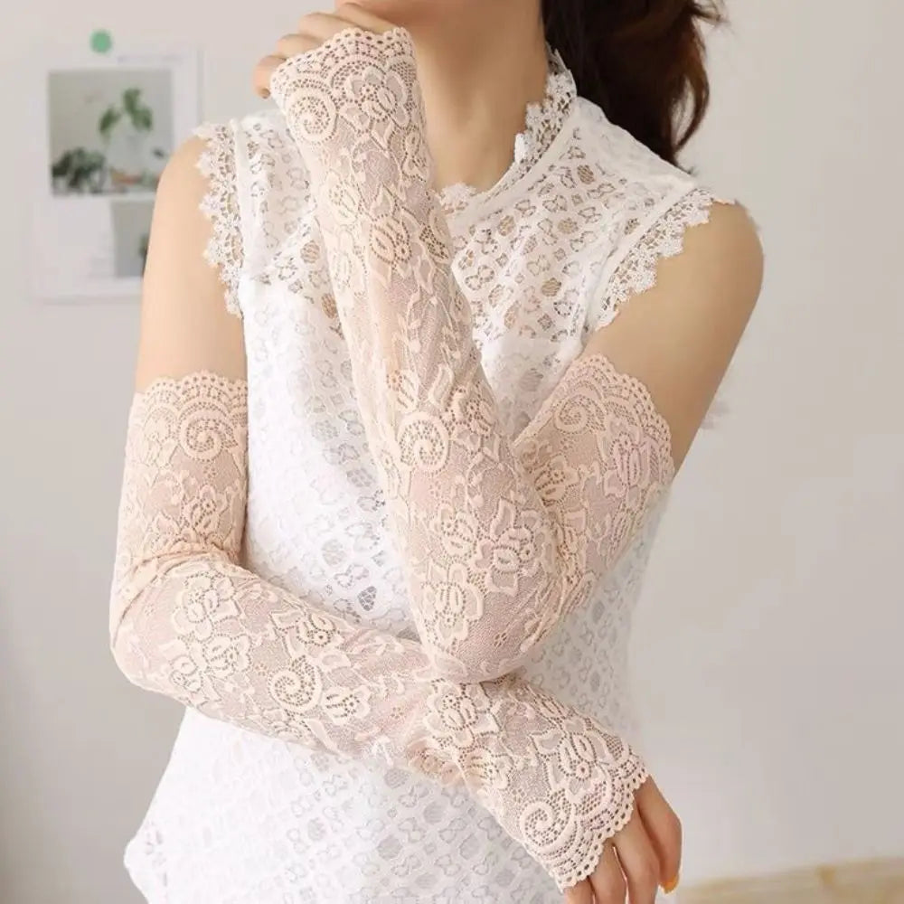 Close-up of a woman wearing sheer beige lace anti-sunburn arm sleeves on her arms.