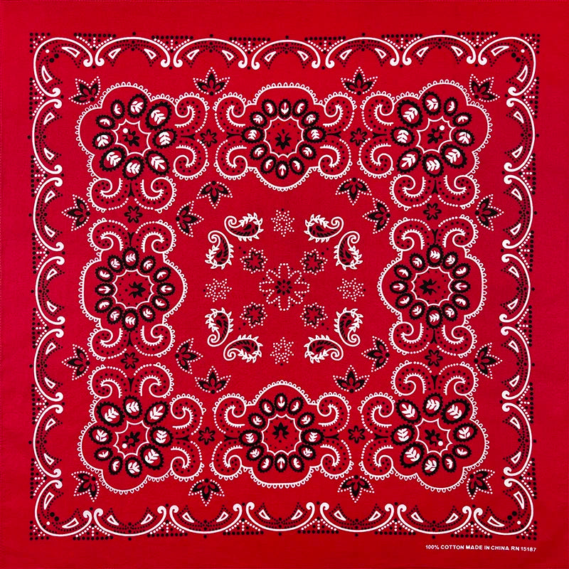 A red fabric with white embroidery featuring a detailed floral pattern.
