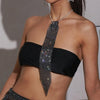A woman models a black strapless top and a long crystal rhinestone sequin neck tie necklace.