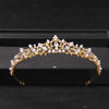 Gold-toned bridal tiara headpiece adorned with clear crystals and white pearls.