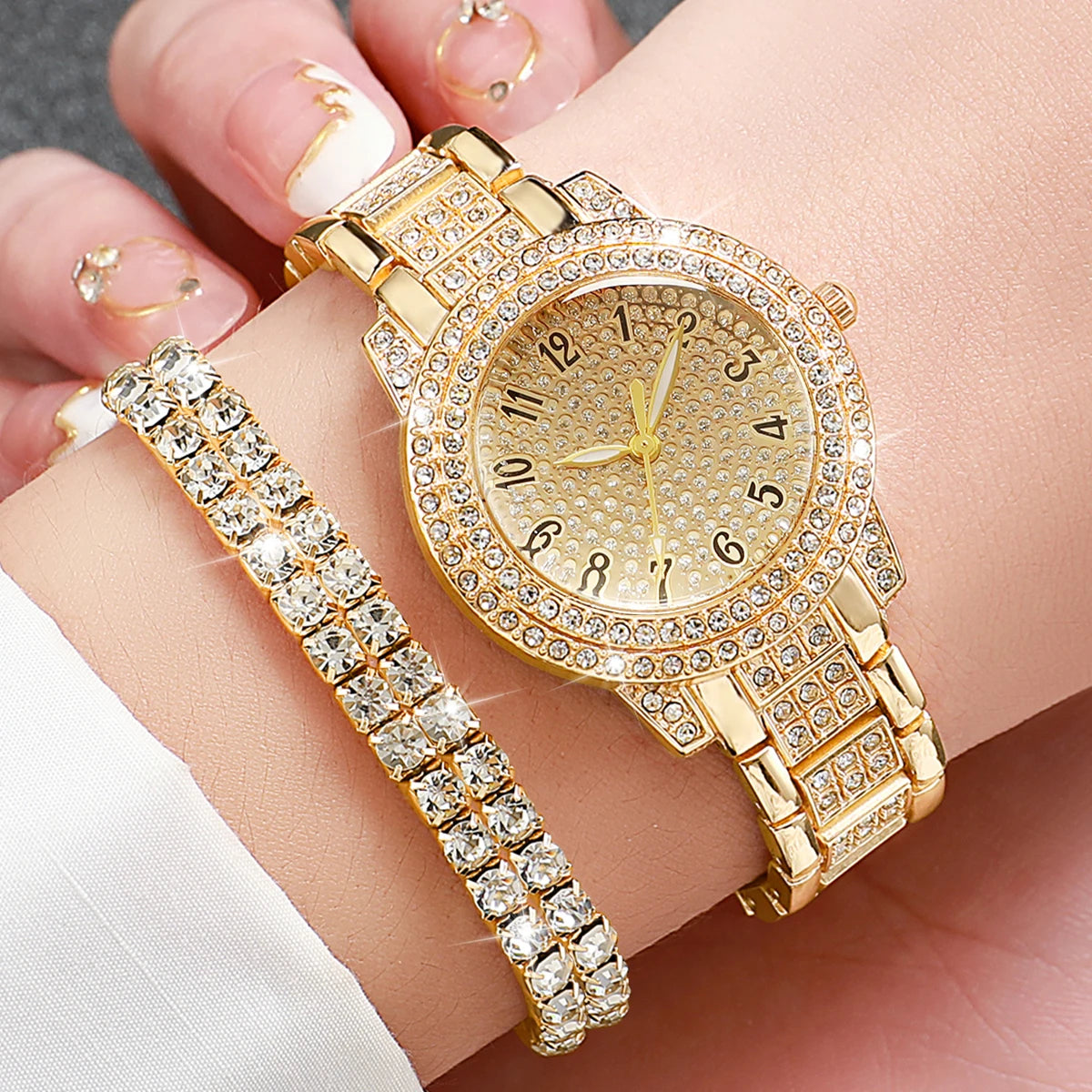 A gold steel quartz watch set featuring a wristwatch and a matching bracelet displayed on a hand.