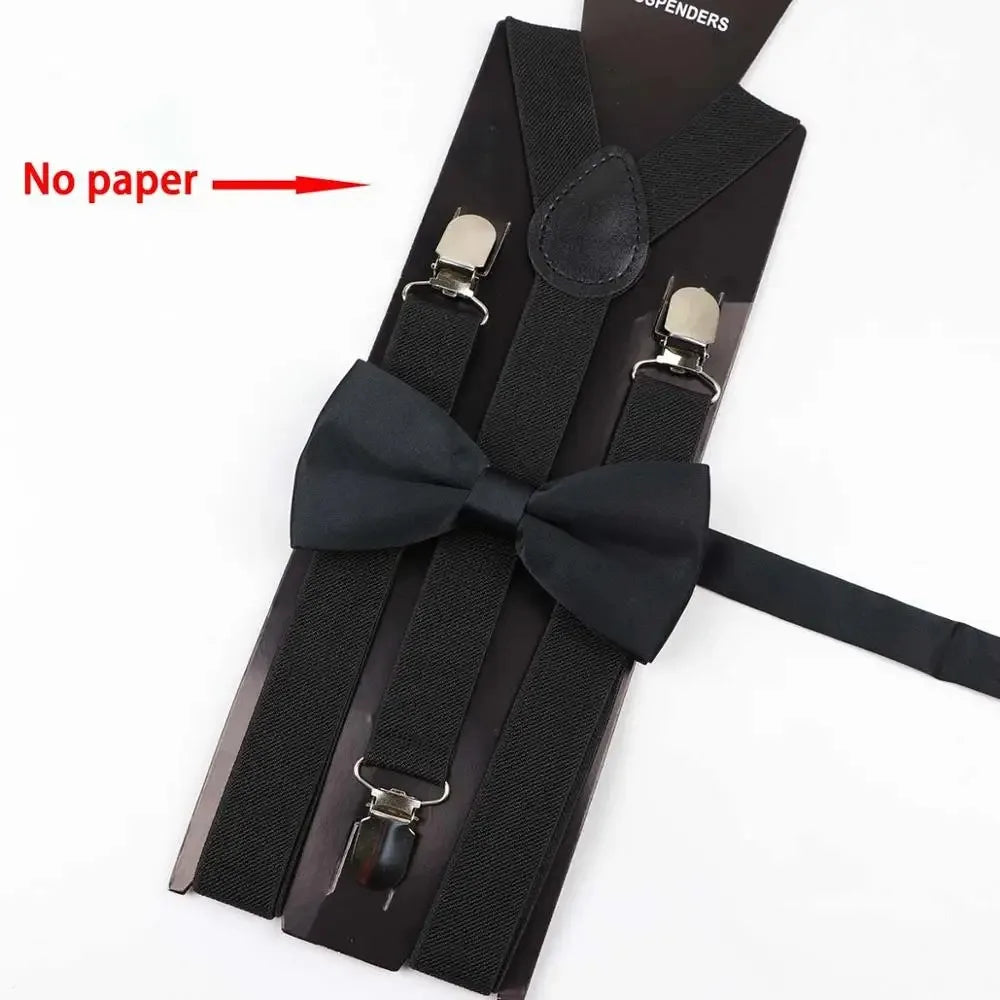 A set of black adjustable polyester suspenders and bow ties with metal clips shown against a white background.