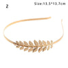 A gold leaf headband with a delicate vine design for bridal or party wear.