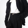 A black blazer worn over a white top and black trousers, featuring an elegant gold PU belt.