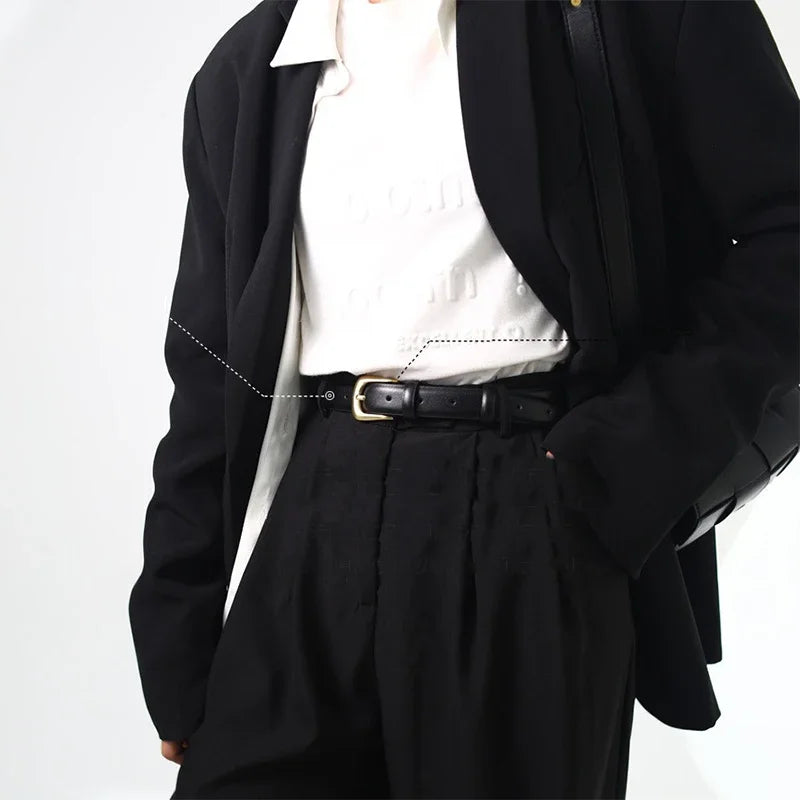 A black blazer worn over a white top and black trousers, featuring an elegant gold PU belt.