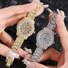 A hand holds two elegant rhinestone quartz fashion watches, one gold-toned and one silver-toned.