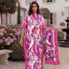 A woman models a pink and purple tropical floral print abaya scarf outdoors in a garden setting.