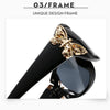 Schwarze Wrap-Around-Sonnenbrille mit goldfarbener Schmetterlingsverzierung