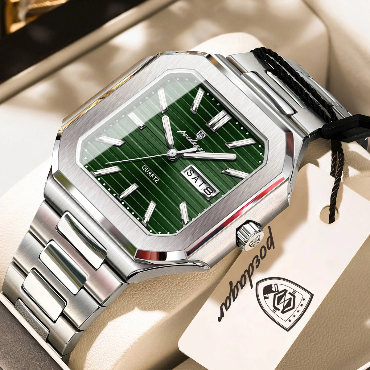 A stainless steel watch with a green dial and silver bezel is displayed on a light background.