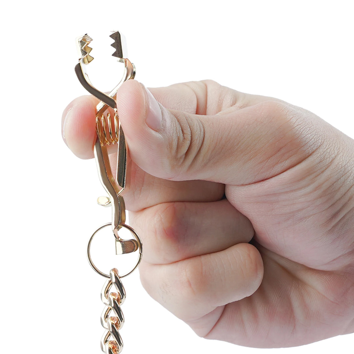 A hand holds a durable metal glove clip holder with a decorative charm.
