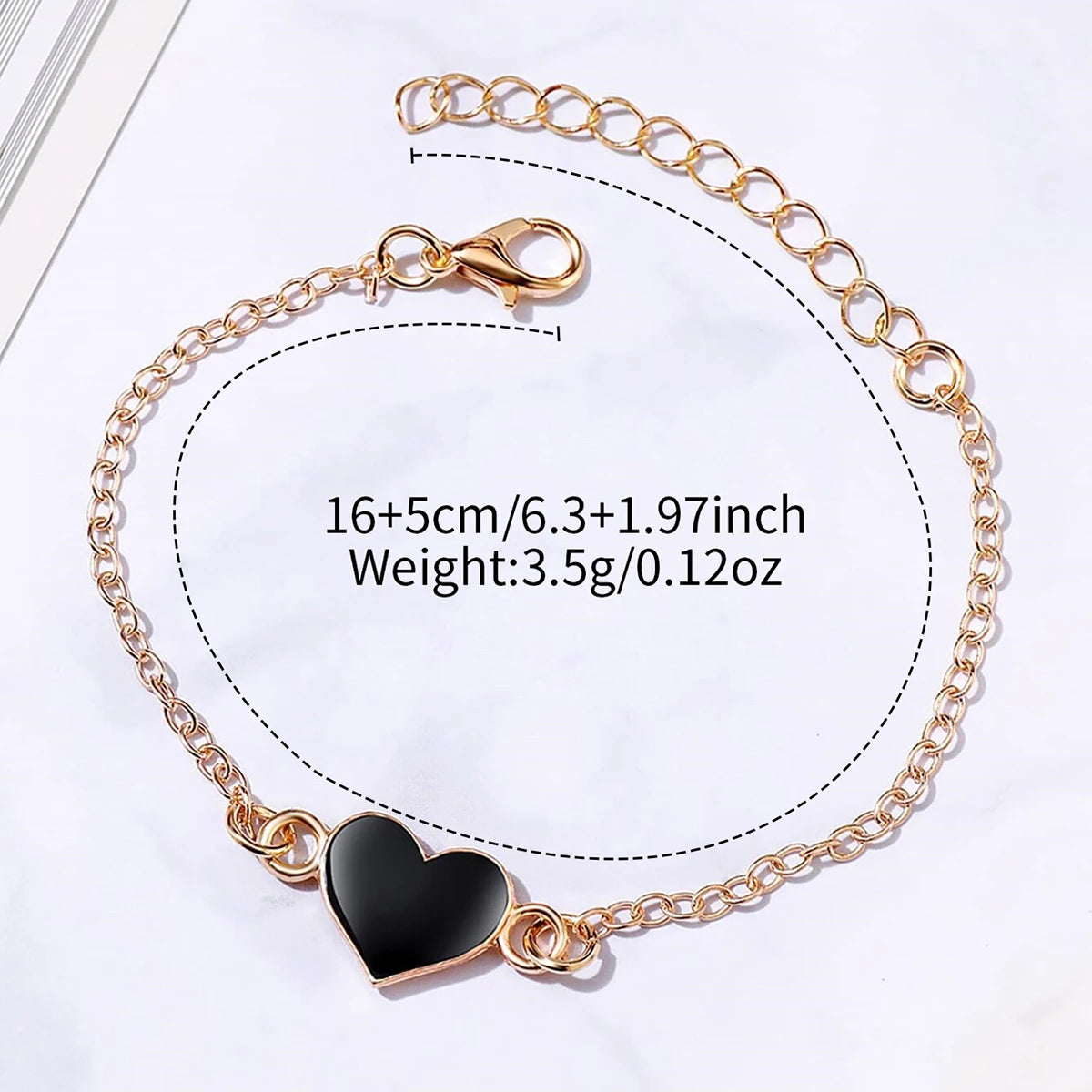 Gold chain necklace with a black heart pendant and a square leather watch set for women