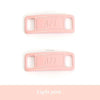 A light pink plastic charm with the letters AFJ stamped on it.