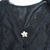 Dark gray velvet shirt with black lace trim and a white pearl button cover