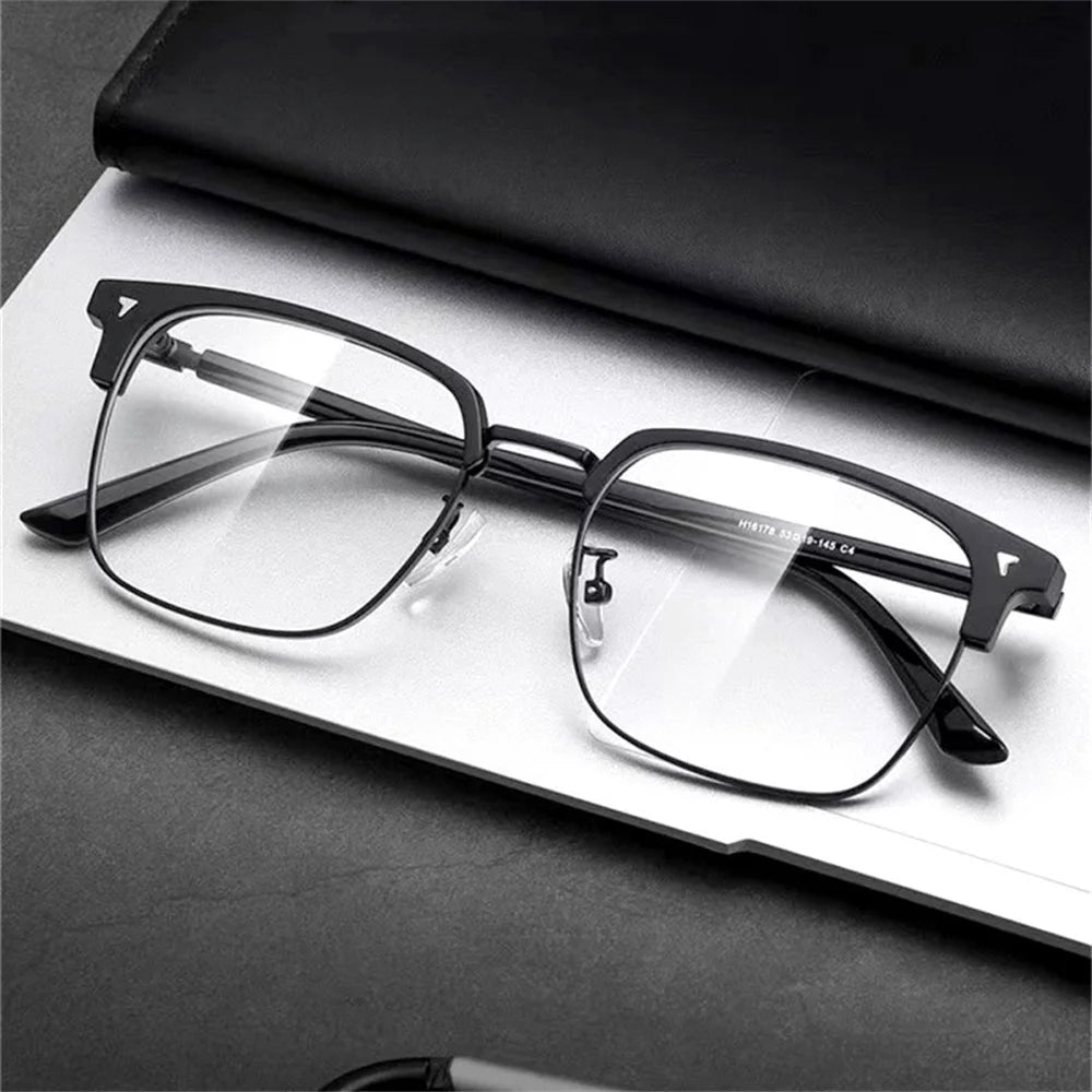 A pair of clear anti-blue light eyeglasses resting on a white surface.