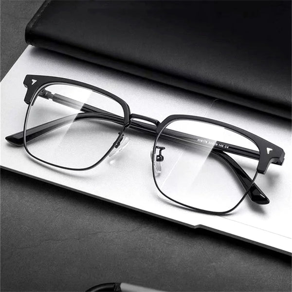 A pair of clear anti-blue light eyeglasses resting on a white surface.