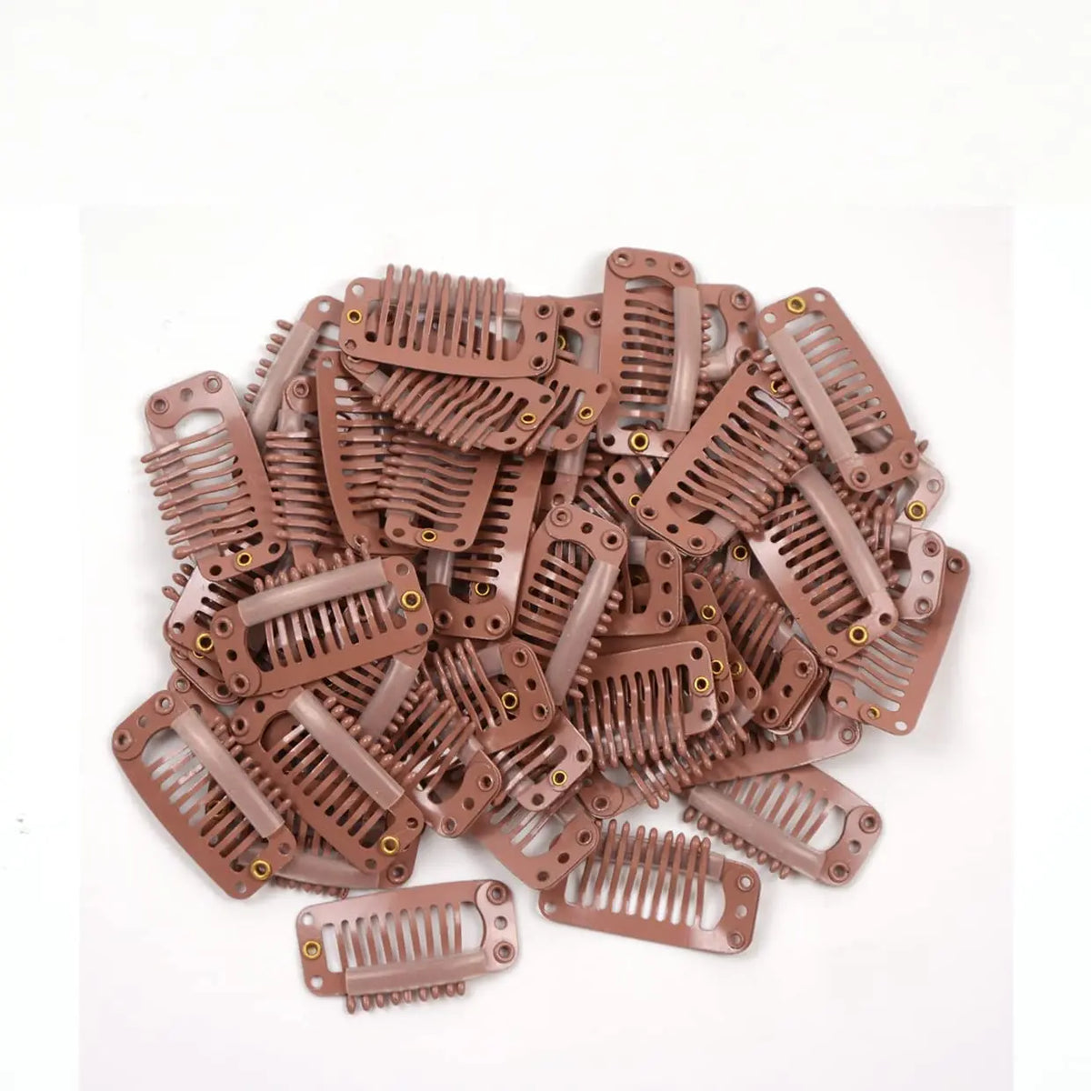 A pile of brown hair extension snap clips used for wigs.