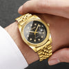 A gold-toned wristwatch with a black dial and rhinestone accents is worn on a person's wrist.
