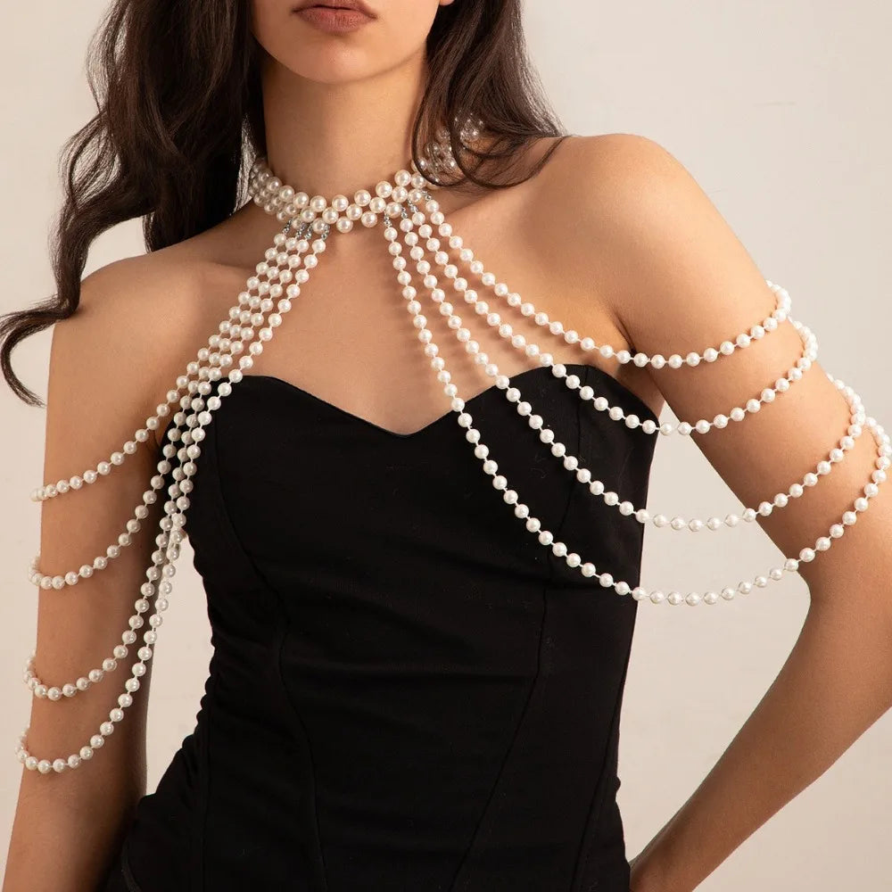 A woman models an imitation pearl statement necklace set with multiple strands draped across her décolletage.
