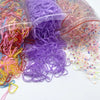 A collection of colorful disposable hair scrunchies in various shades including pink, purple, and yellow, packaged in clear p