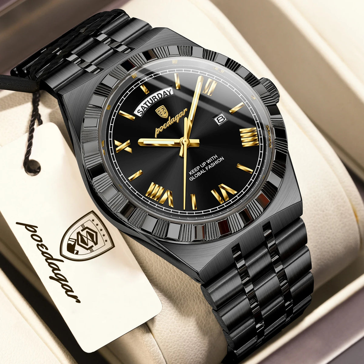 A black leather strap watch with a silver bezel and gold-toned hands is displayed in a box.
