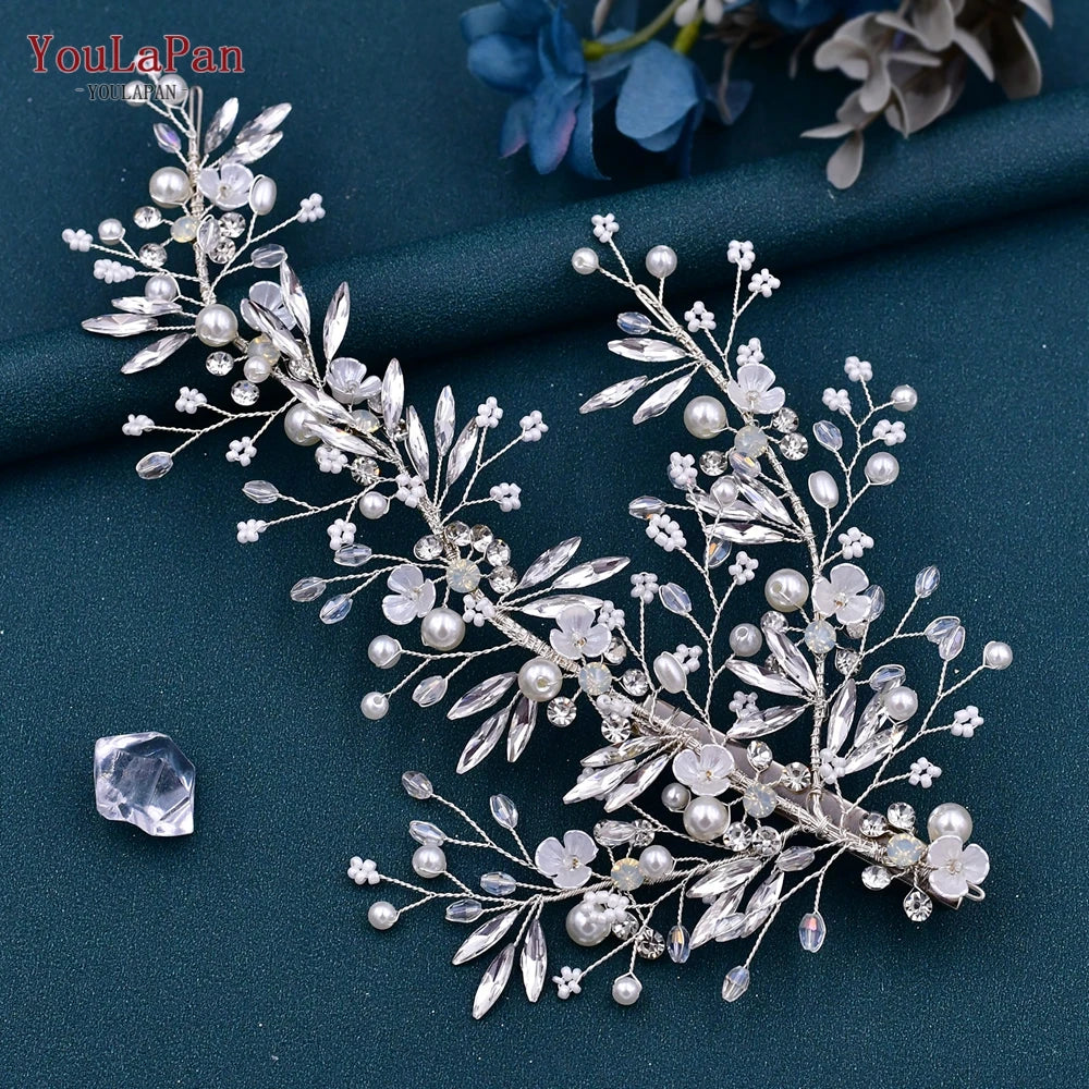 A delicate silver and clear rhinestone bridal headband featuring floral and pearl embellishments.
