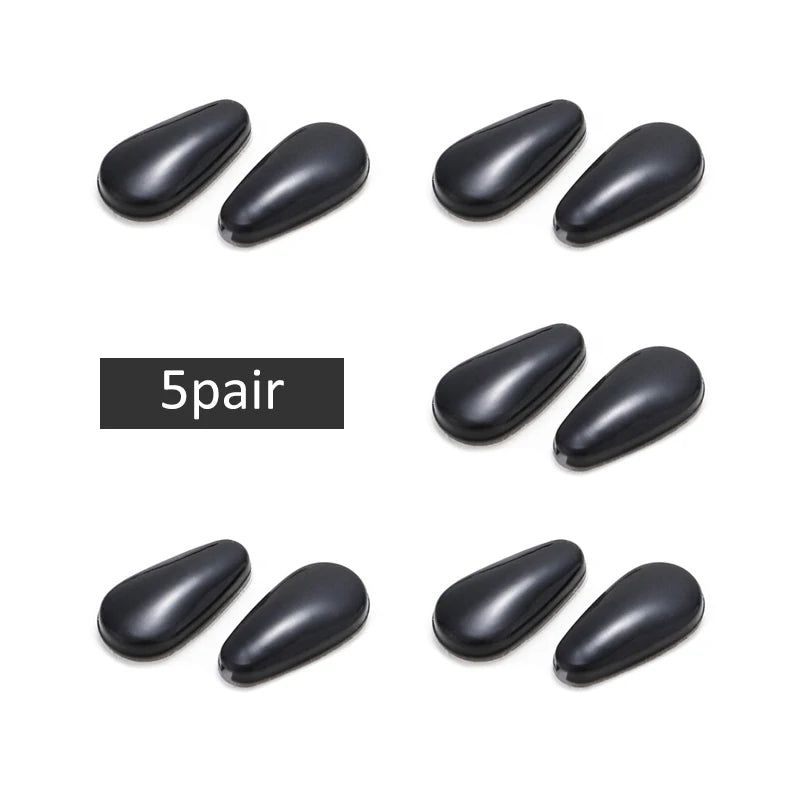 Five pairs of black silicone nose pads for eyeglasses shown individually.