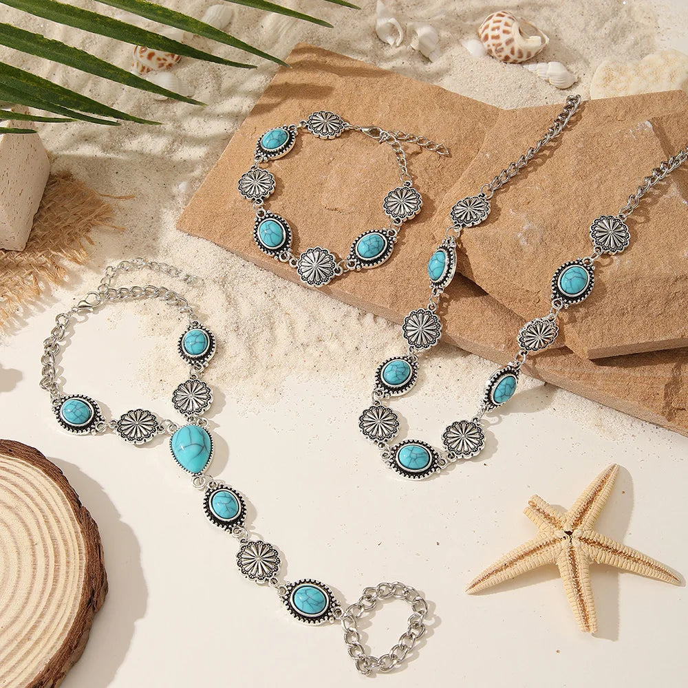 A set of silver and turquoise beaded necklaces and bracelets displayed on a natural background.