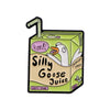 A green enamel pin shaped like a goose with a straw and text that reads honk