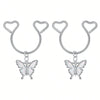 A pair of silver heart dangle non-piercing nipple rings with cubic zirconia charms.