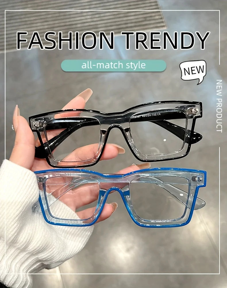 A hand holds a pair of clear and blue-framed glasses against a light background.
