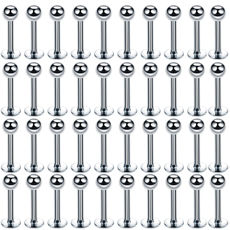 A grid of silver stainless steel labret lip rings for piercings.