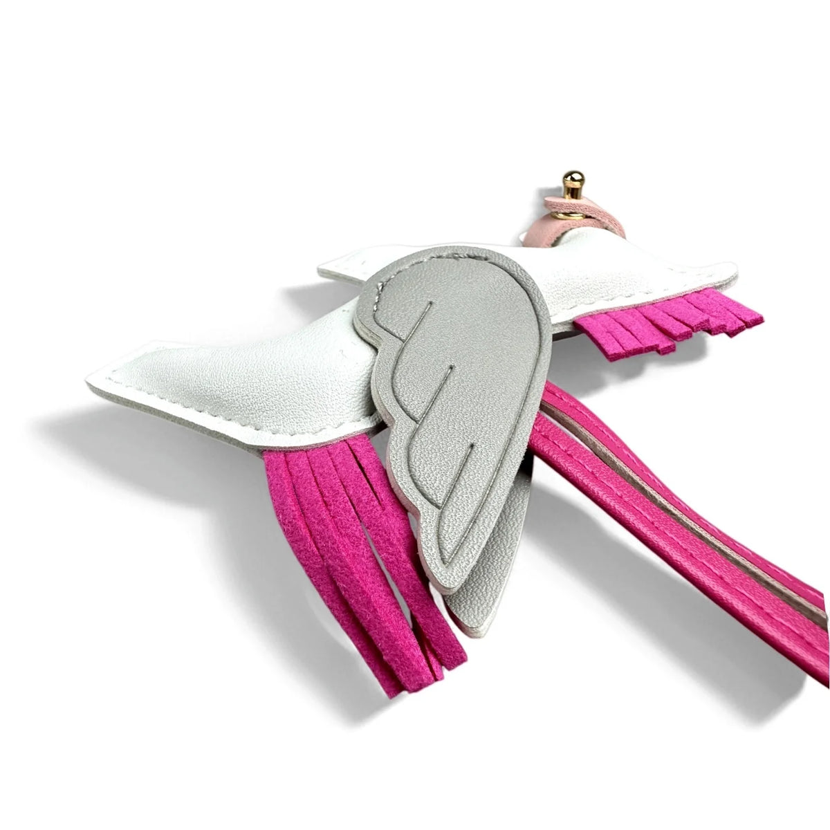 A keychain featuring a white wing design with pink tassels and a gold-colored loop.
