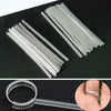 A set of invisible ring sizer tools showing multiple thin, clear metal strips and a ring sizing tool.